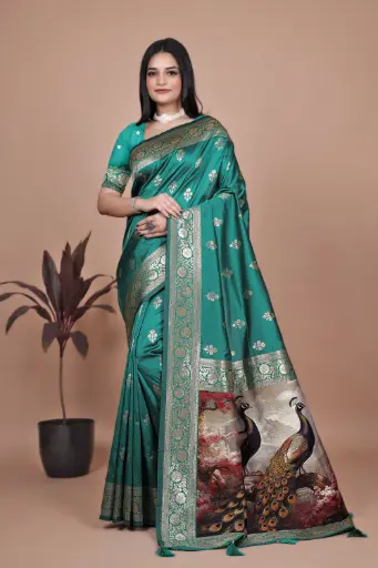 Color: Emerald Green with Multi-tone Artistic Pallu  Fabric: Soft, lustrous Banarasi Silk  Design: Golden zari woven motifs and wide traditional border
