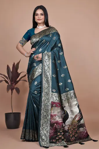 Color: Deep Teal with Multicolor Artistic Pallu  Fabric: Premium Banarasi Silk  Design: Gold zari motifs and intricately woven border  Pallu: Richly detailed peacock-themed scenic artwork  Occasion: Wedding, Festive, Party Wear  Saree Length: 5.5 meters | Blouse Piece: 0.8 m Unstitched